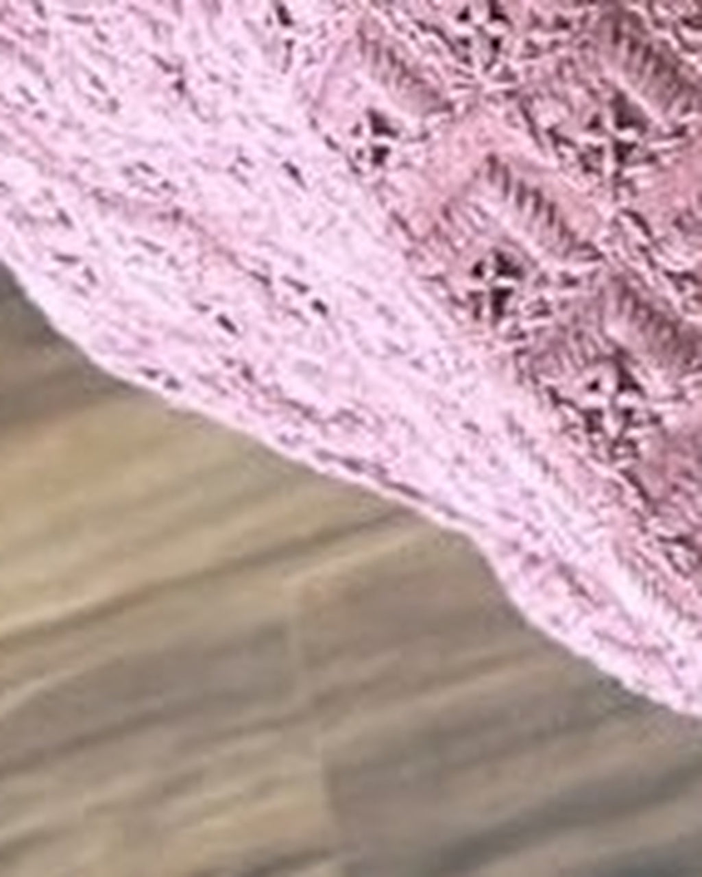 Mauve chikankari-style fabric close-up, real photograph